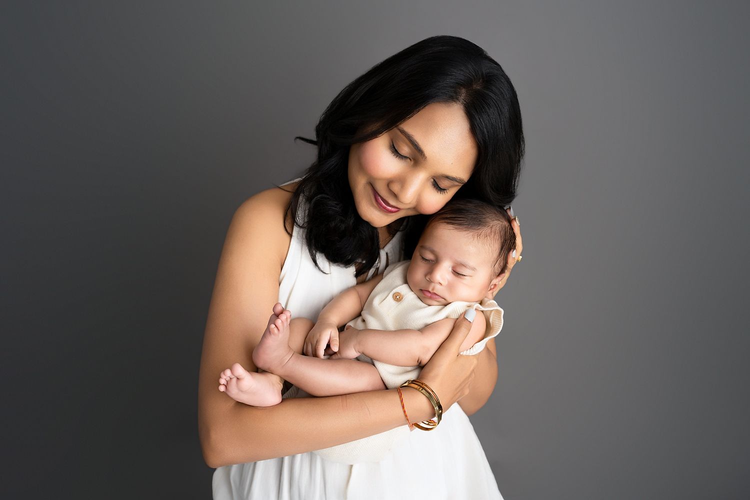 Baby photographed with family in the studio